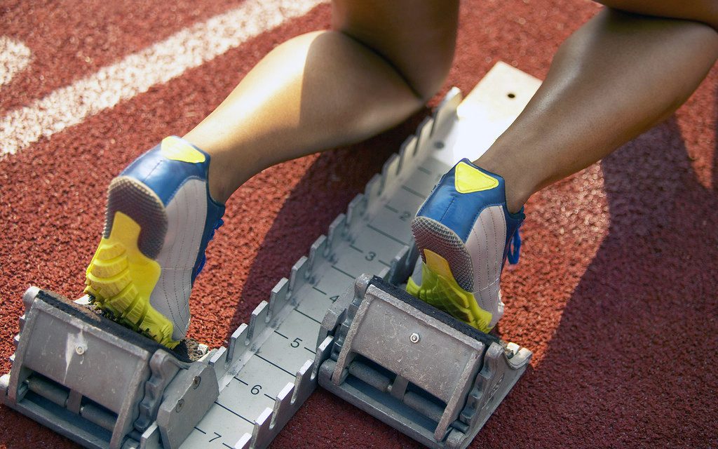 Athletic Feet of Runner Positioned at Starting Block