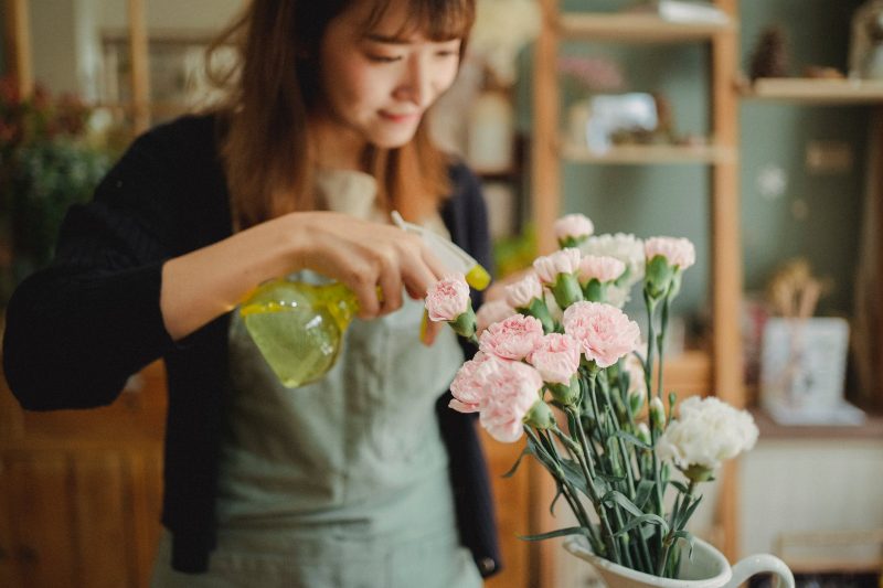 female business owner misting flowers