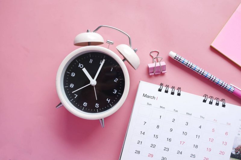 computer and calendar with office supplies