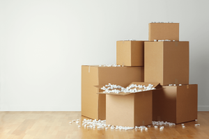 A stack of boxes with packing peanuts spilling out