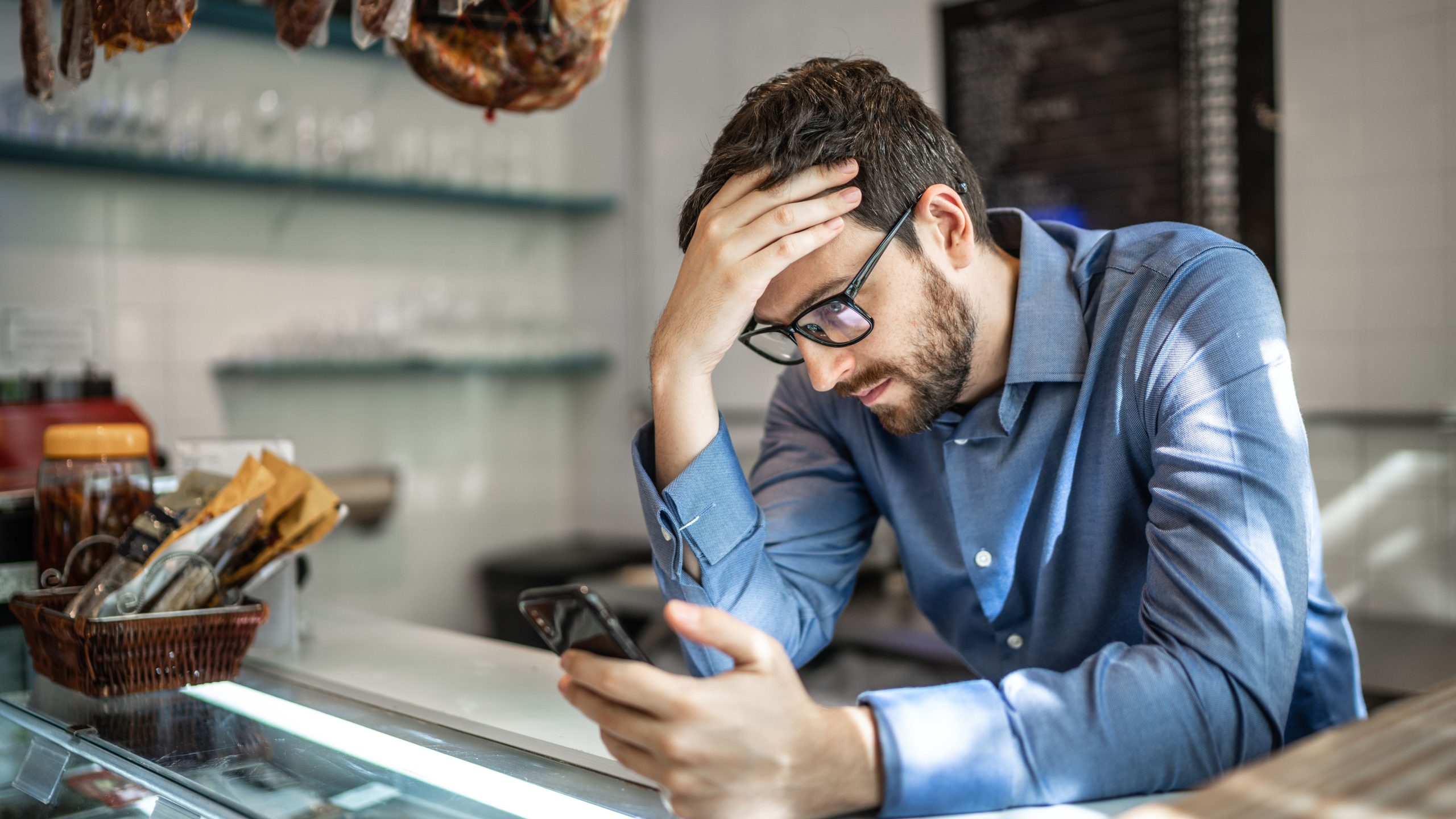 A Canadian small business owner worrying over cash flow problems