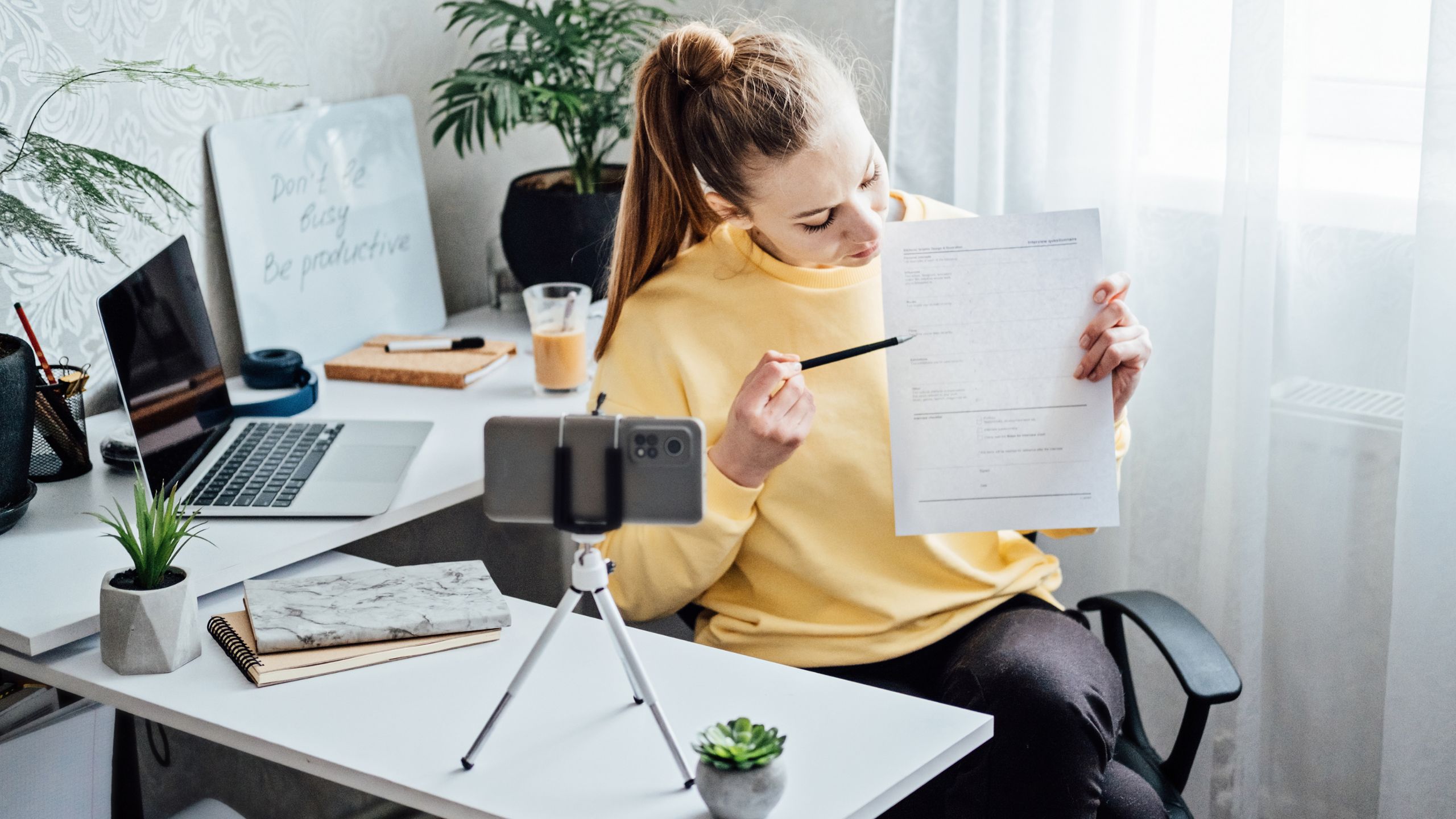 A woman working at her home office to keep her business going during hustle culture.